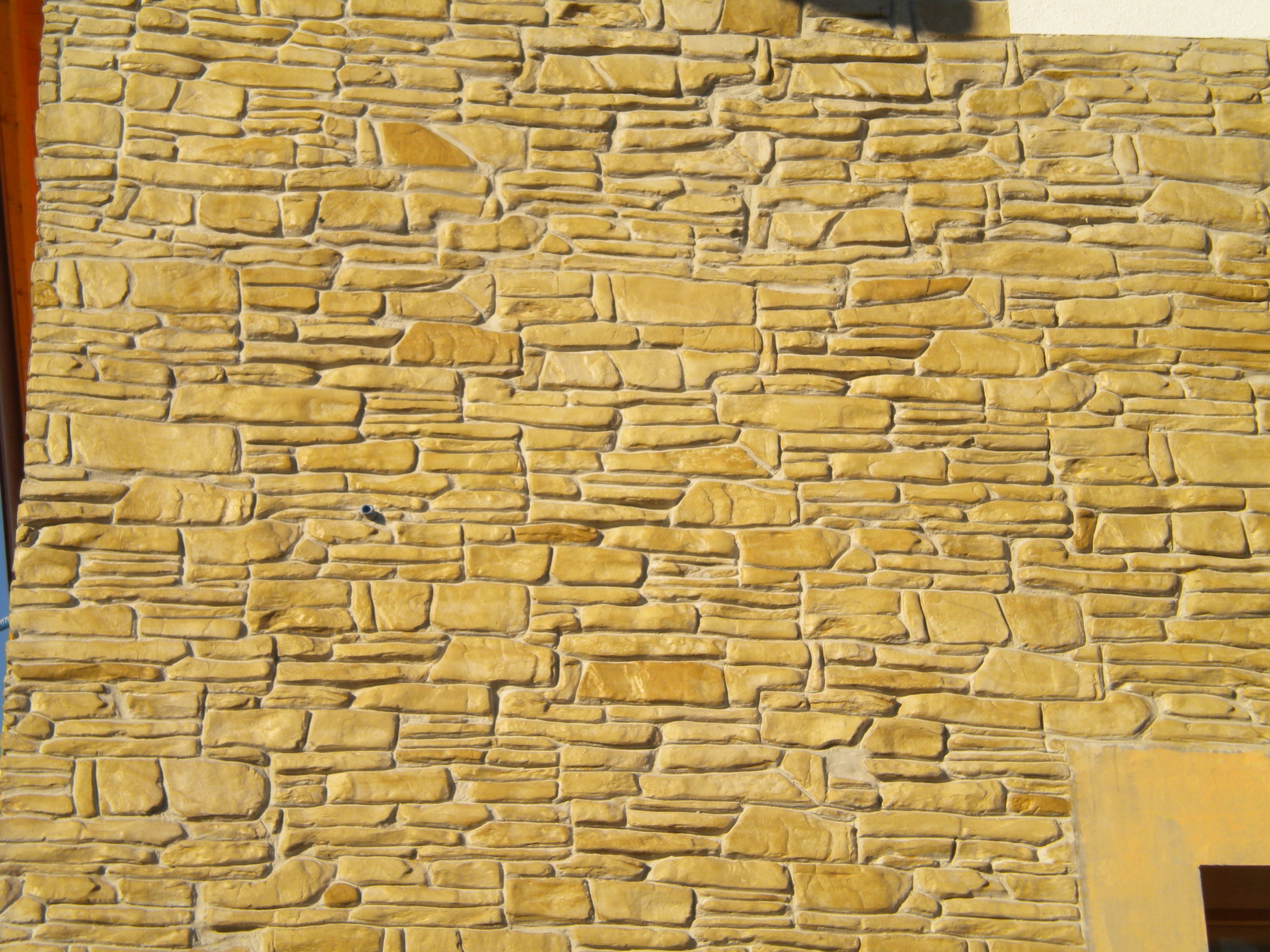 muro stampato intonaco effetto pietra, mattone e legno su superfici  verticali